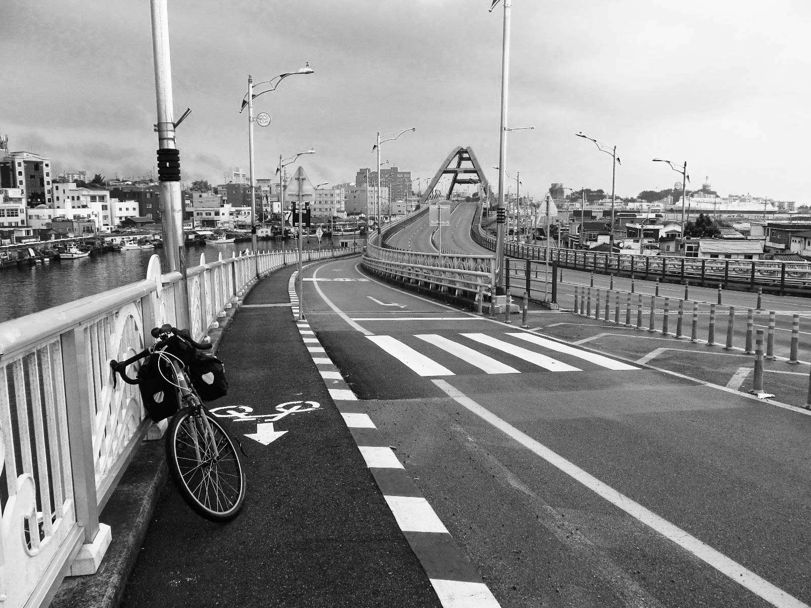 Cycling across busy bridge in Sokcho, South Korea.