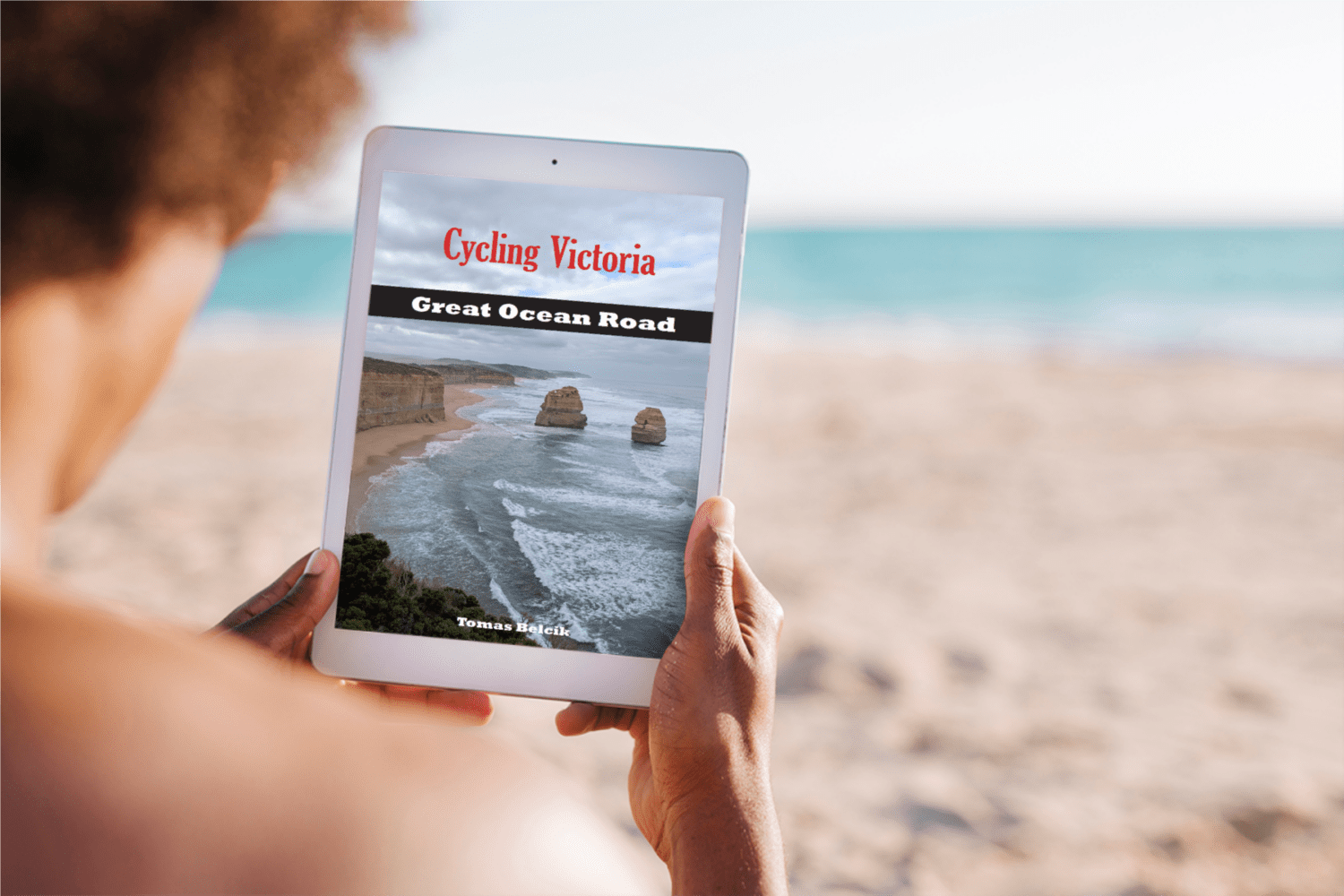 Great Ocean Road cycling guide on reader's tablet at the beach.