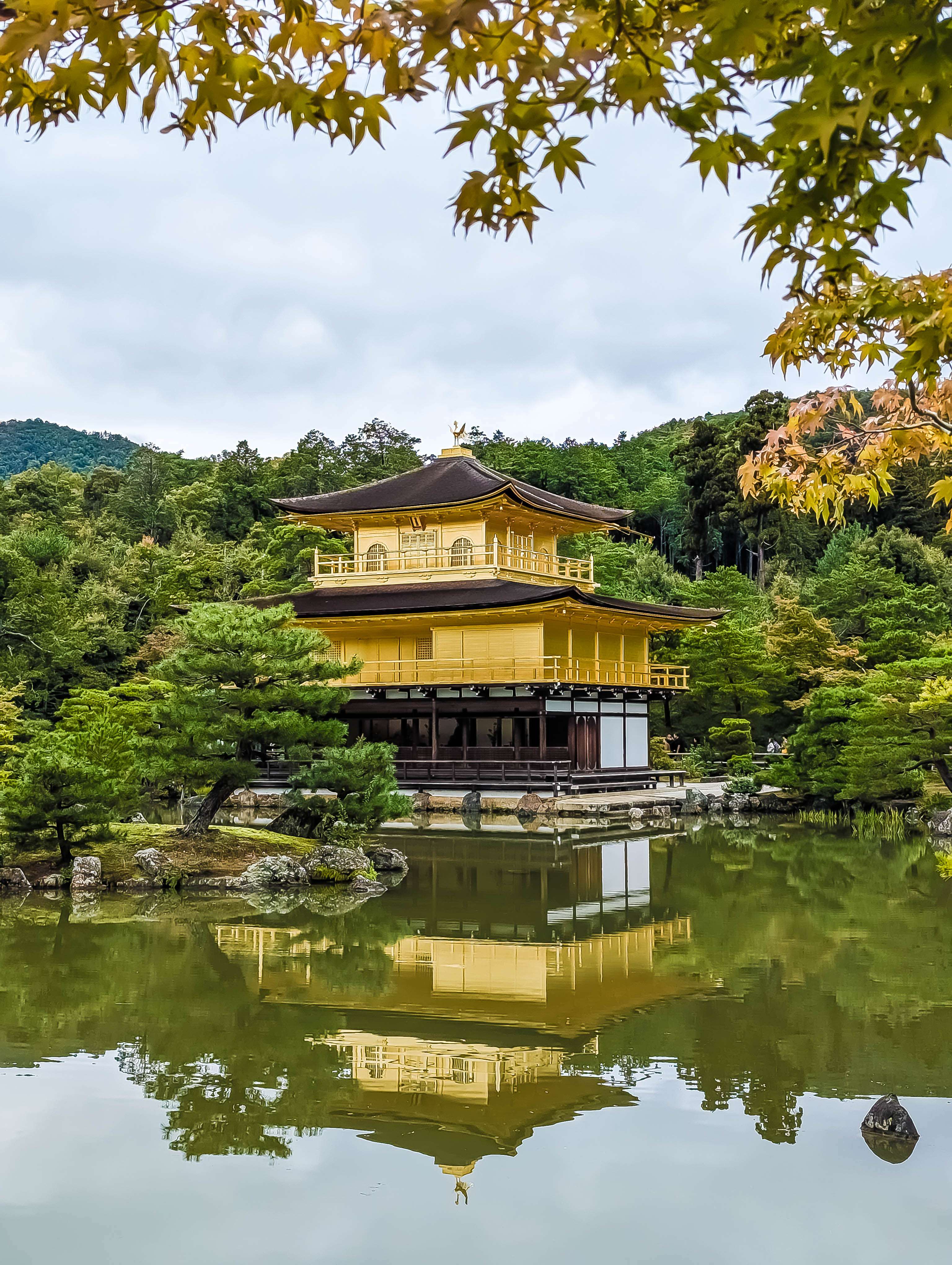 Kinkaku-ji, the Golden Pavilion, situated on the edge of a pond called Kyōko-chi ("Mirror Pond") is surrounded by a meticulously maintained, historic Japanese strolling garden.