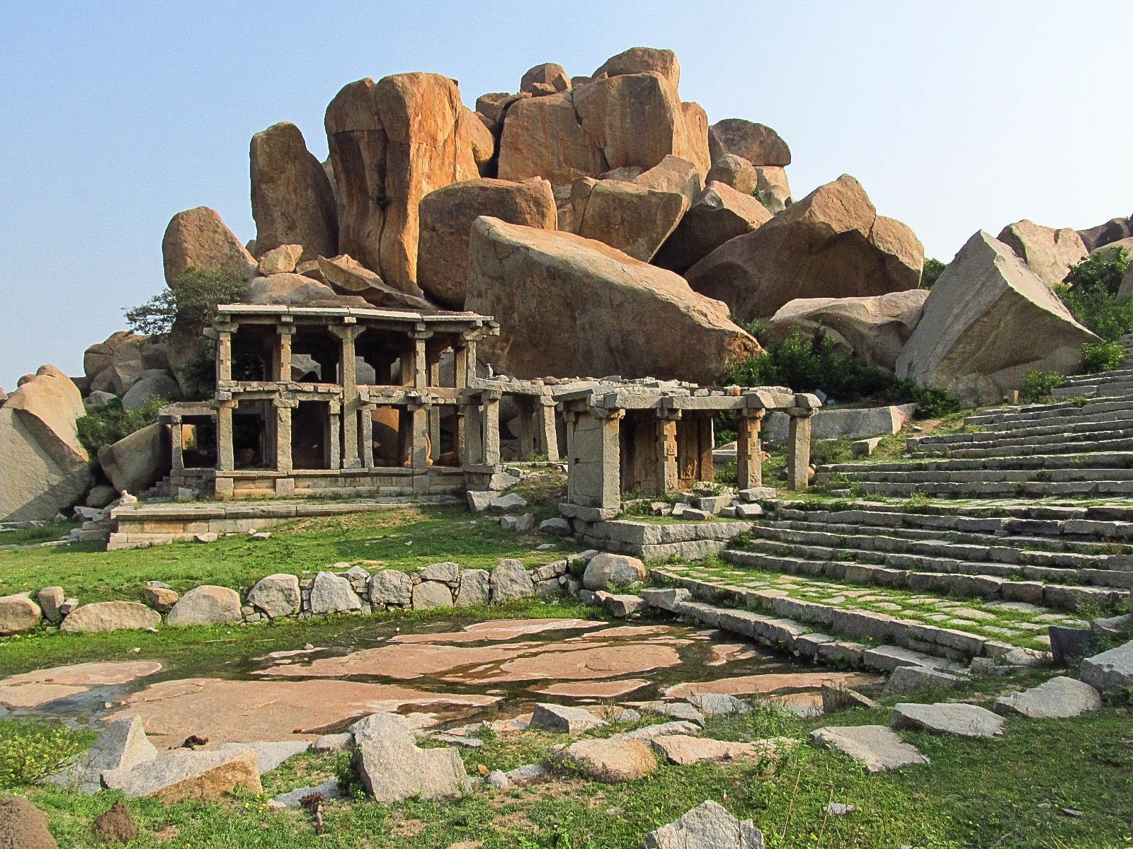 Temple rises from among giant rocks, scattered yet connected, the entire setting taking on an almost unreal quality.